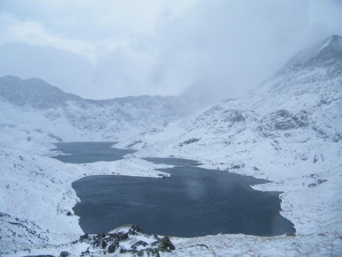 View in Snowdonia. Cloudy sky, lying snow.